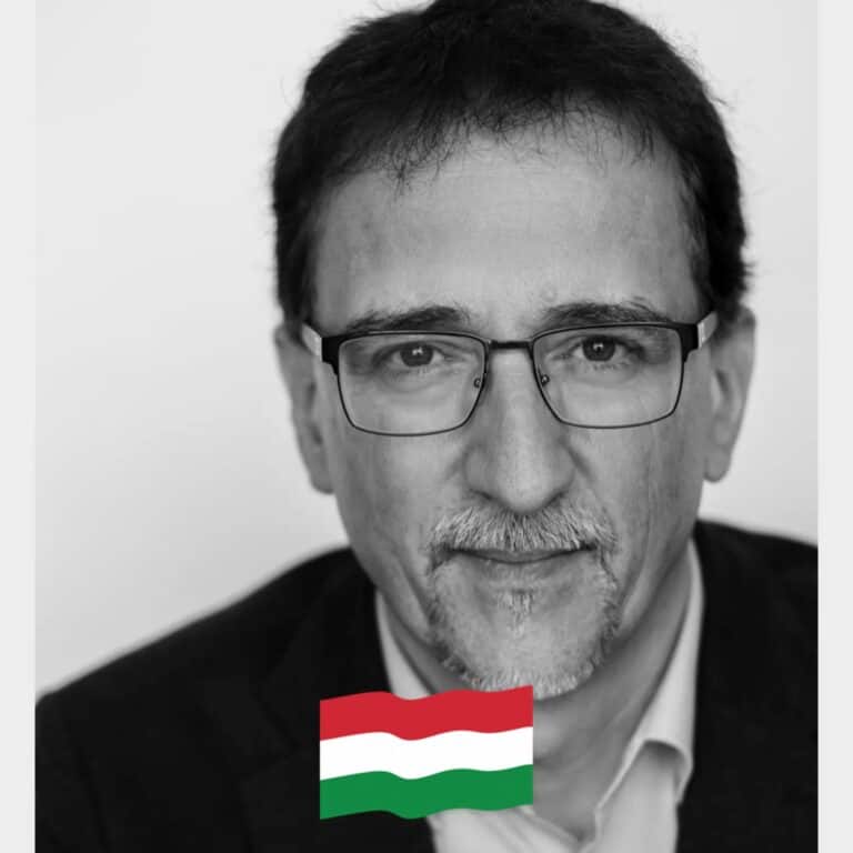 Minta fekete-fehér portré férfi, szemüveg, magyar zászlóval a kép alján.