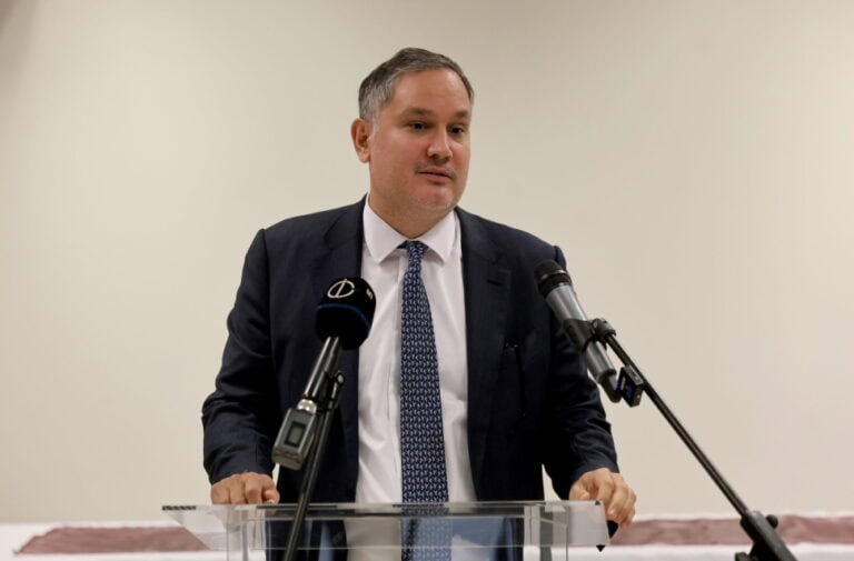 Politikus beszédet tart egy konferencián, mikrofonokkal a stúdióban.