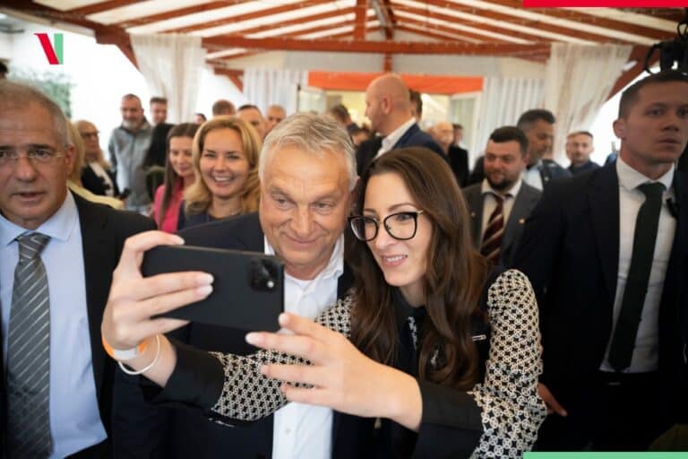 Fiatal nő és idősebb férfi selfie-t készítenek egy eseményen.