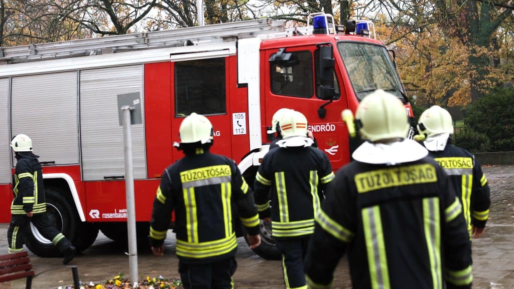 EMERGENCY firefighters in action during training or an incident on a rainy day.