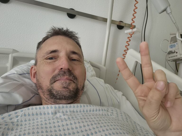 Egészségesnak tűnő beteg az ágyban, kórházi környezetben.