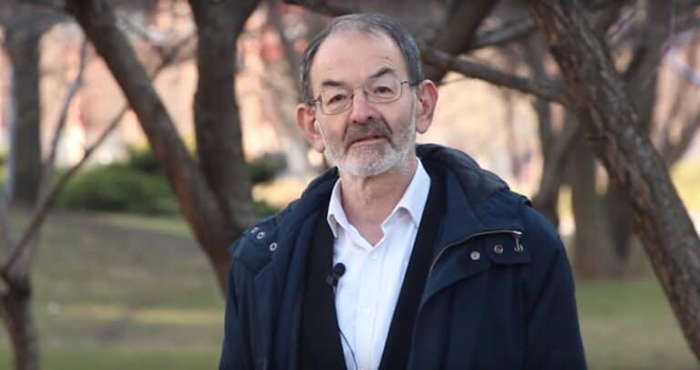 Álló férfi portré, parkban, őszi hangulatban, szemüveges, elegáns öltözetben.