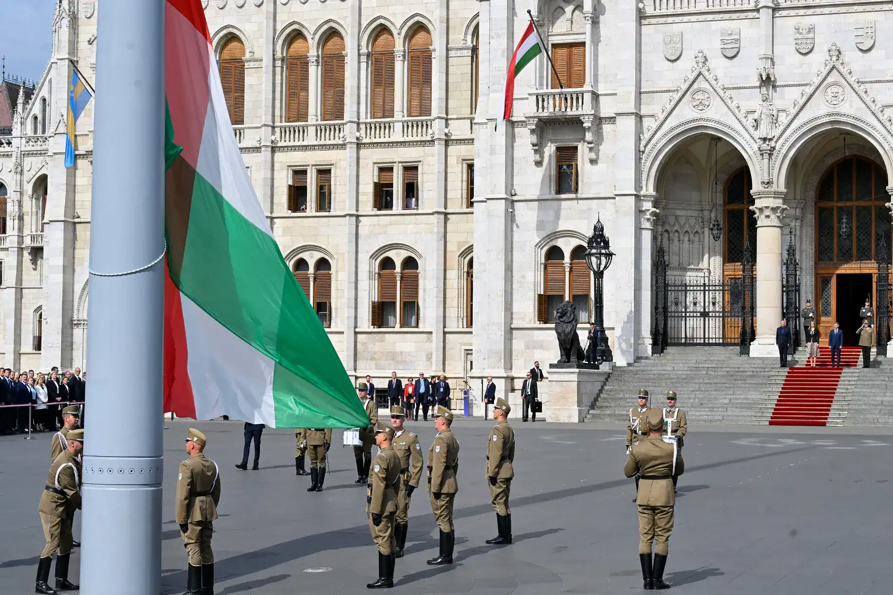 Magyar katonák a Parlament előtt, nemzeti zászlóval, biztonsági intézkedés közben.