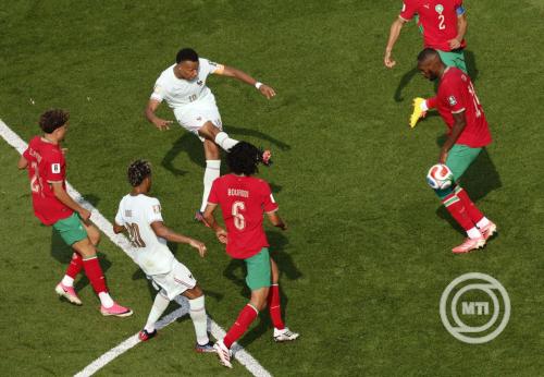 Marokkói játékosok és két portugál játékos a labdáért küzdenek a pályán.